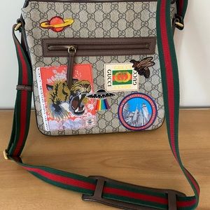 Gucci Supreme messenger bag with patches.
